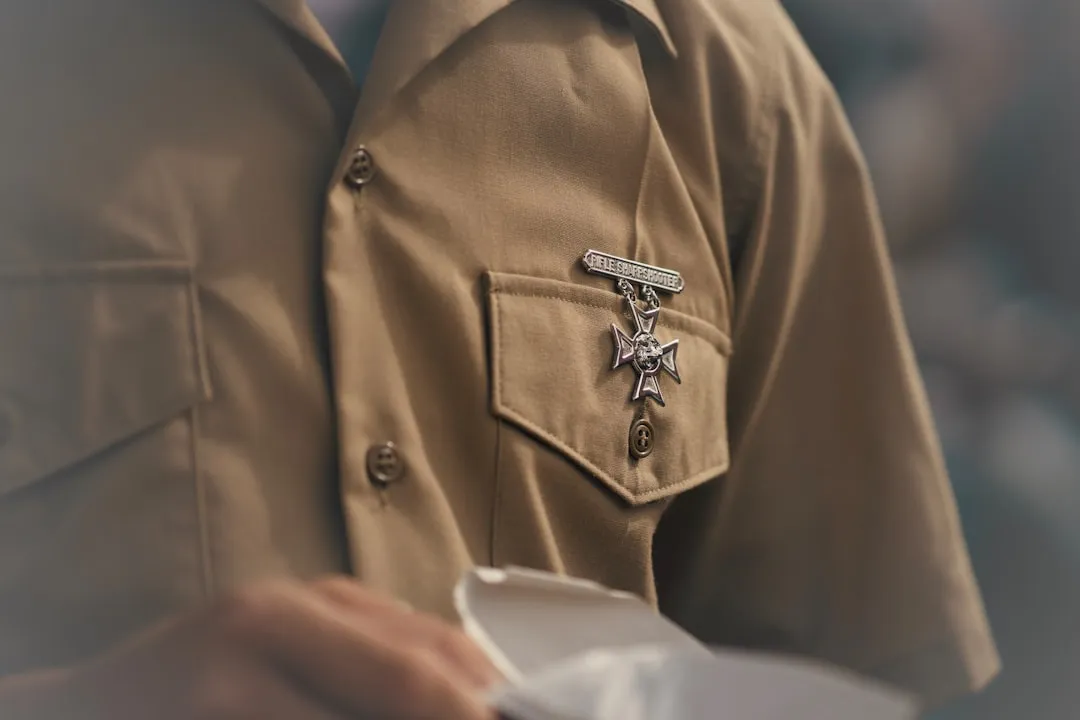 A technician wearing a uniform with a certification badge - certified garage door repair technician in dripping springs tx