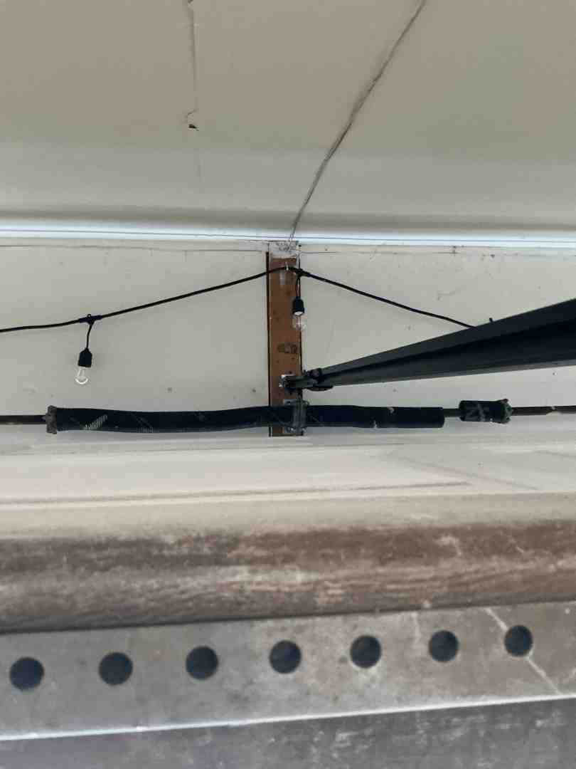 technician inspecting a garage door spring - "I need a reliable company for overhead garage door repair in Austin, TX. Can you give me a few options known for fast service?"