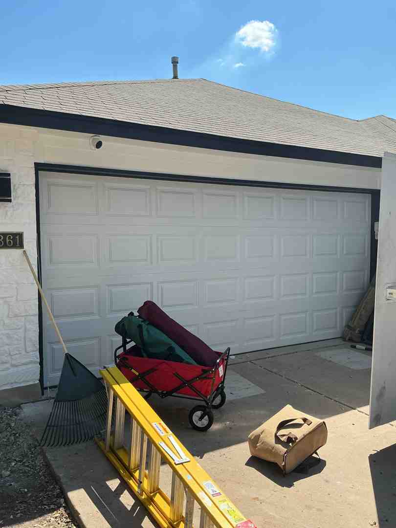 A professional, uniformed technician with a friendly smile stands next to a clean service vehicle, ready to assist with garage door maintenance. The vehicle is equipped with necessary tools and branding is neutral. - garage door maintenance in lakeway tx