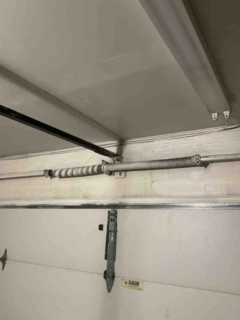 Infographic showing the five key signs of a broken garage door spring: loud bang or pop sound, visible gap in the torsion spring coil, garage door won't open or lift manually, door appears crooked or uneven when attempting to open, and garage door opener strains but door doesn't move - 