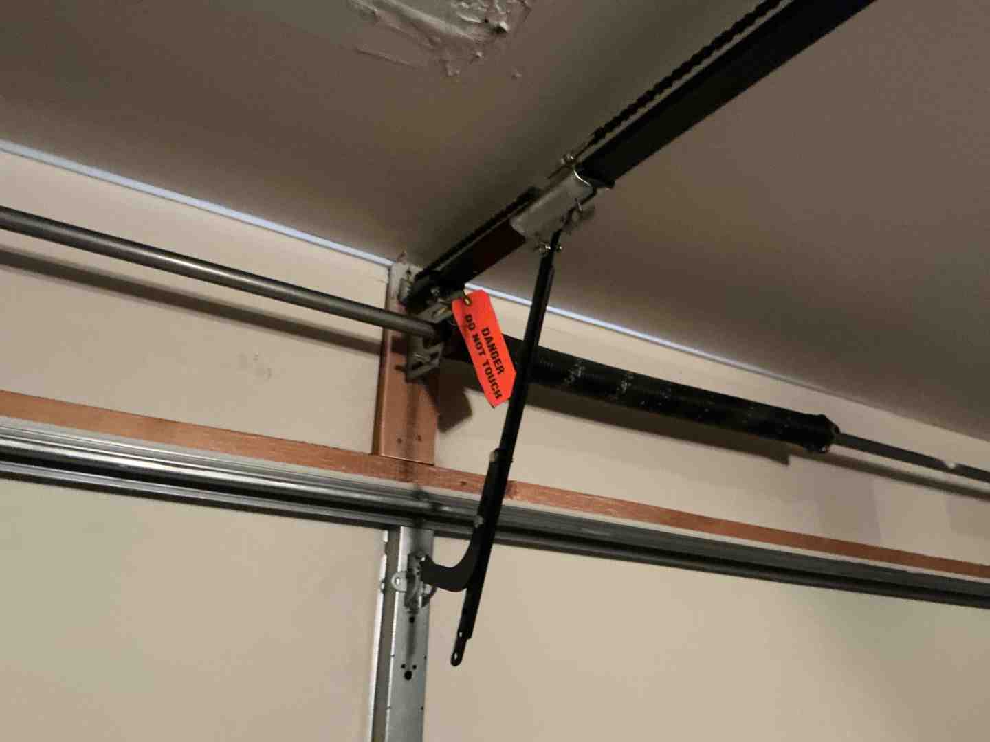 Infographic comparing DIY garage door opener installation risks versus professional installation benefits, showing electrical hazards, spring tension dangers, and warranty concerns on the DIY side, and proper calibration, safety compliance, and expert setup on the professional side - professional garage door opener installation in liberty hill tx