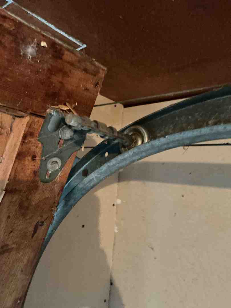 homeowner cleaning garage door tracks - best garage door maintenance in georgetown tx