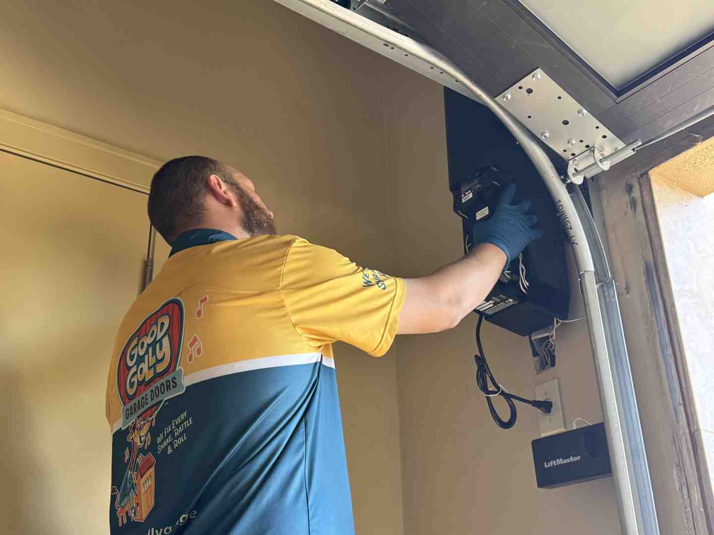 Technician performing garage door inspection - Who can I trust for an honest assessment of my garage door's condition in