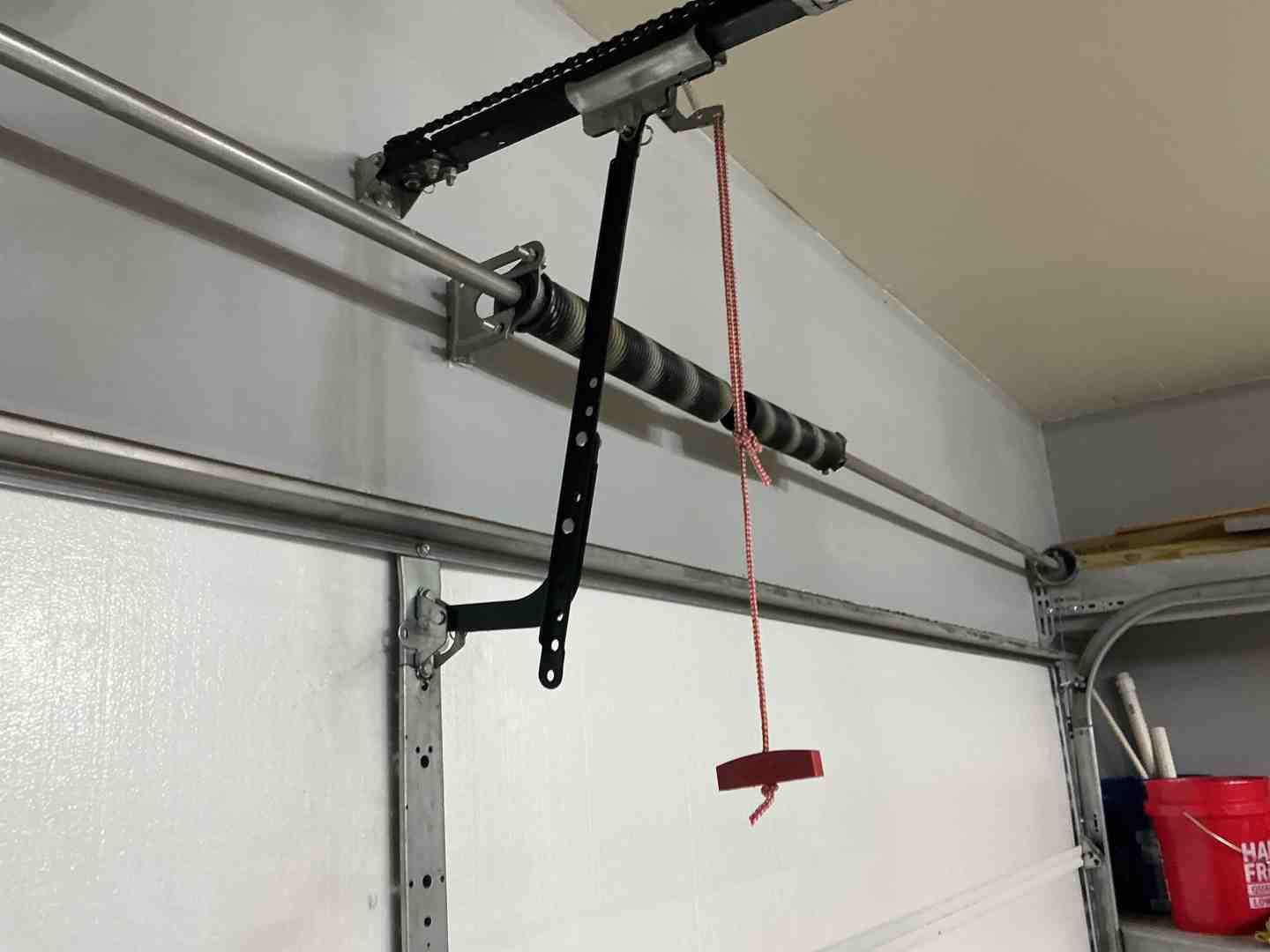 Infographic showing the main components of a garage door opener system including the motor unit, drive mechanism (chain, belt, or screw), safety sensors, wall control panel, remote control, and emergency release cord, with labels explaining how each part works together to safely operate your garage door - Best Garage Door Opener Repair In Cedar Park TX