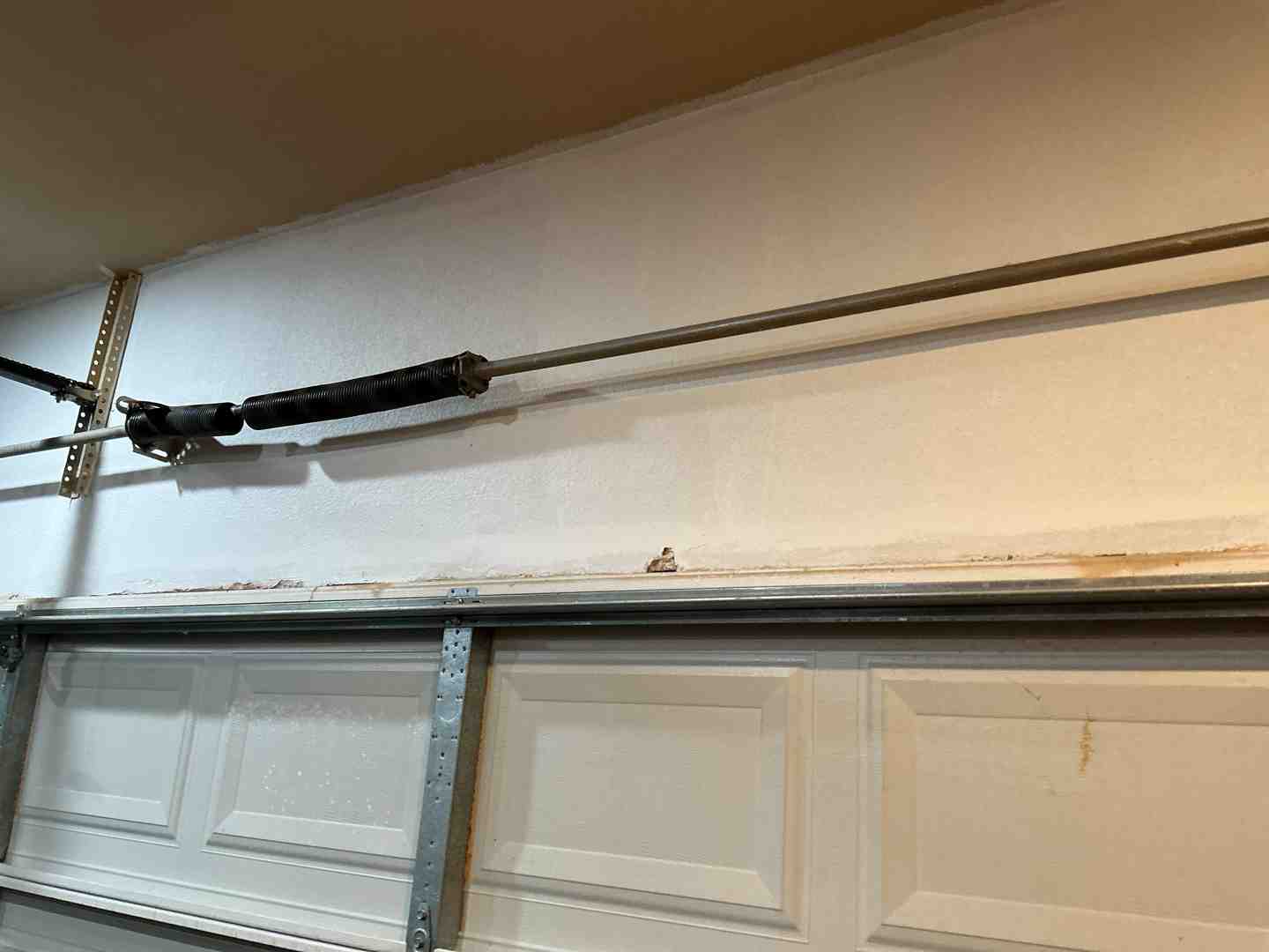 broken garage door torsion spring inside a Pflugerville garage - why is my garage door spring broken in pflugerville tx