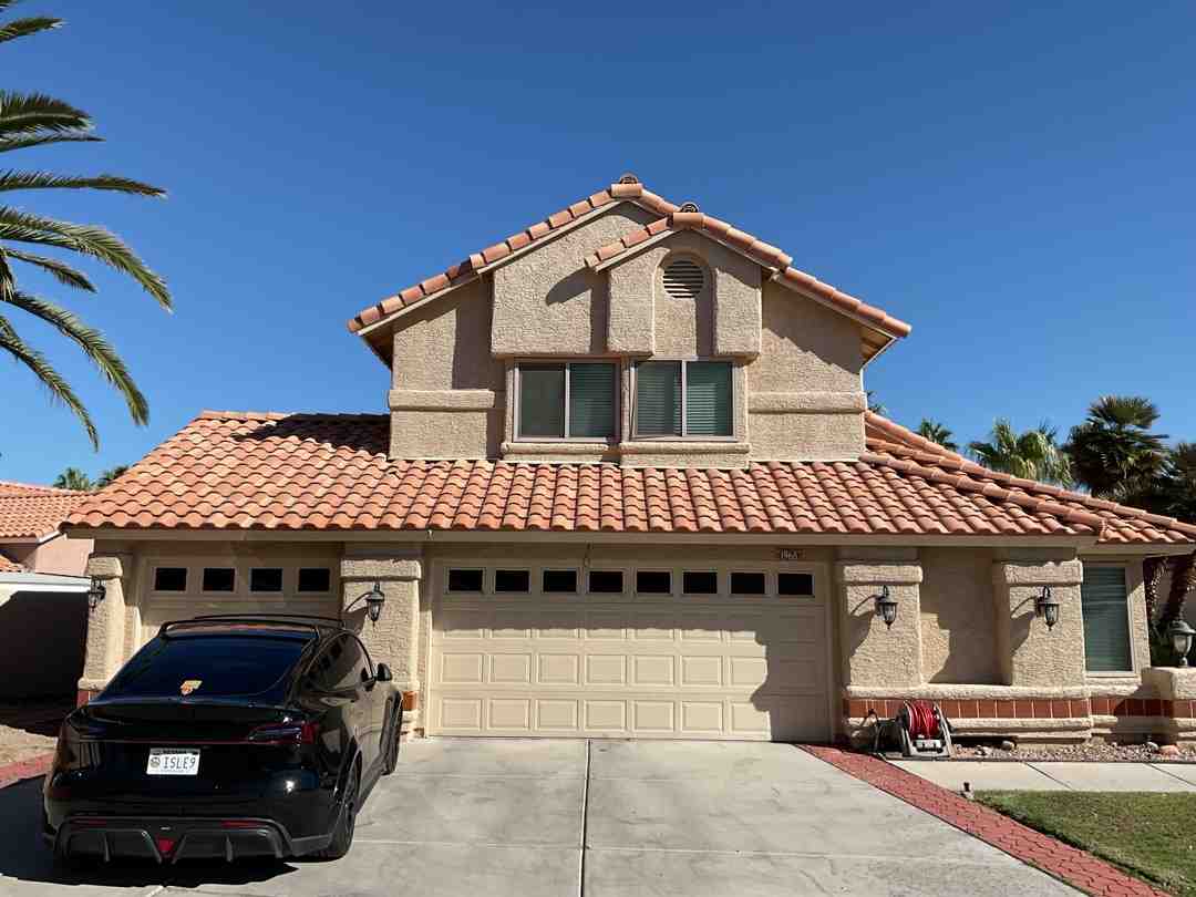 Mediterranean style home in Henderson with stucco walls and clay tile roof - how to pick a garage door style that matches