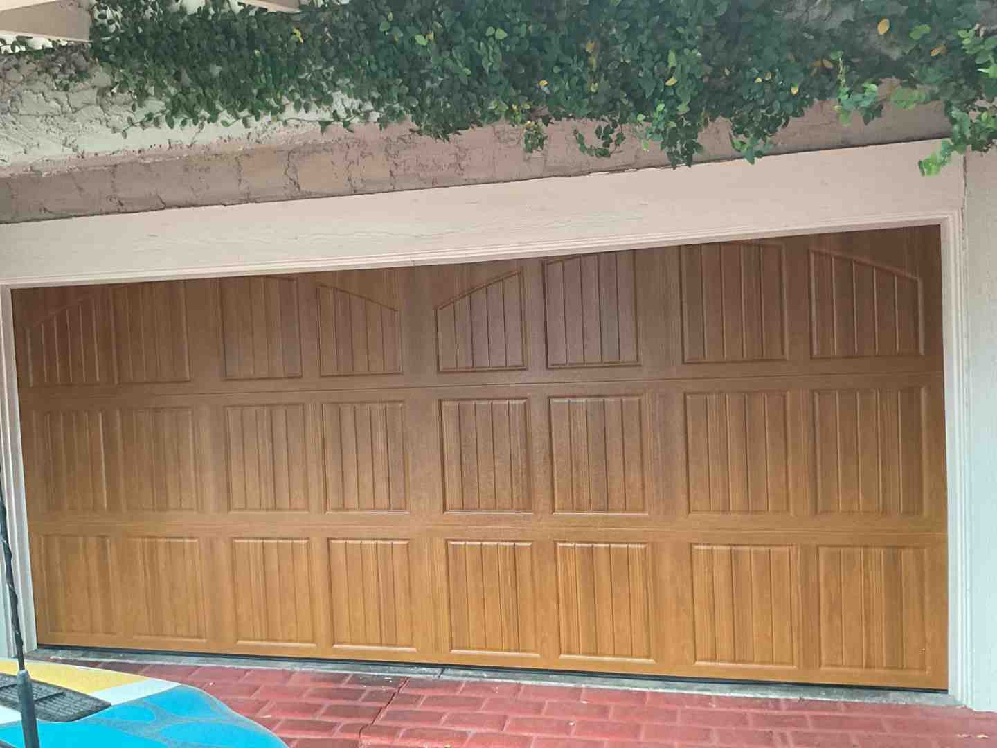 Carriage house garage door on a traditional home with decorative hardware - how to pick a garage door style that matches