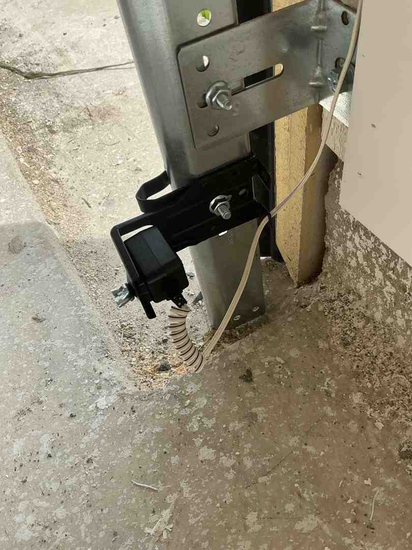 technician aligning garage door safety sensors - what does a professional garage door tune up include technician aligning garage door safety sensors - what does a professional garage door tune up include