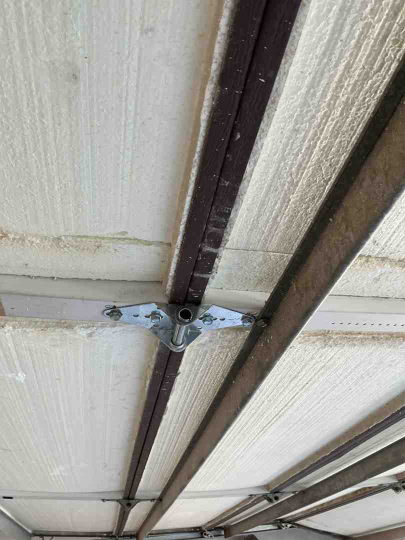 multi-layer sandwich construction garage door showing insulation core - how insulated garage doors improve energy efficiency