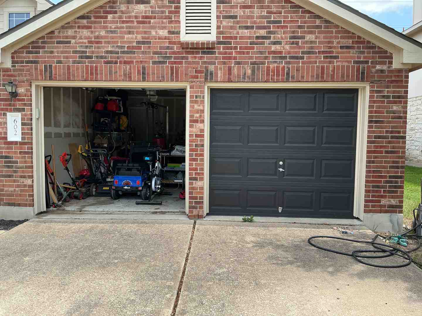 An attached garage in a suburban Austin neighborhood showing the shared wall with the home's interior living space