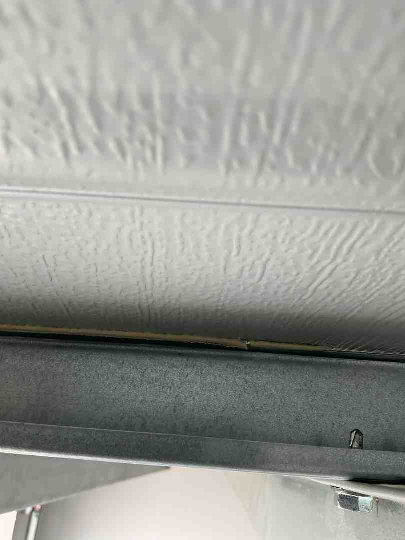 Inside view of an insulated steel garage door showing the tracks and hardware Inside view of an insulated steel garage door showing the tracks and hardware