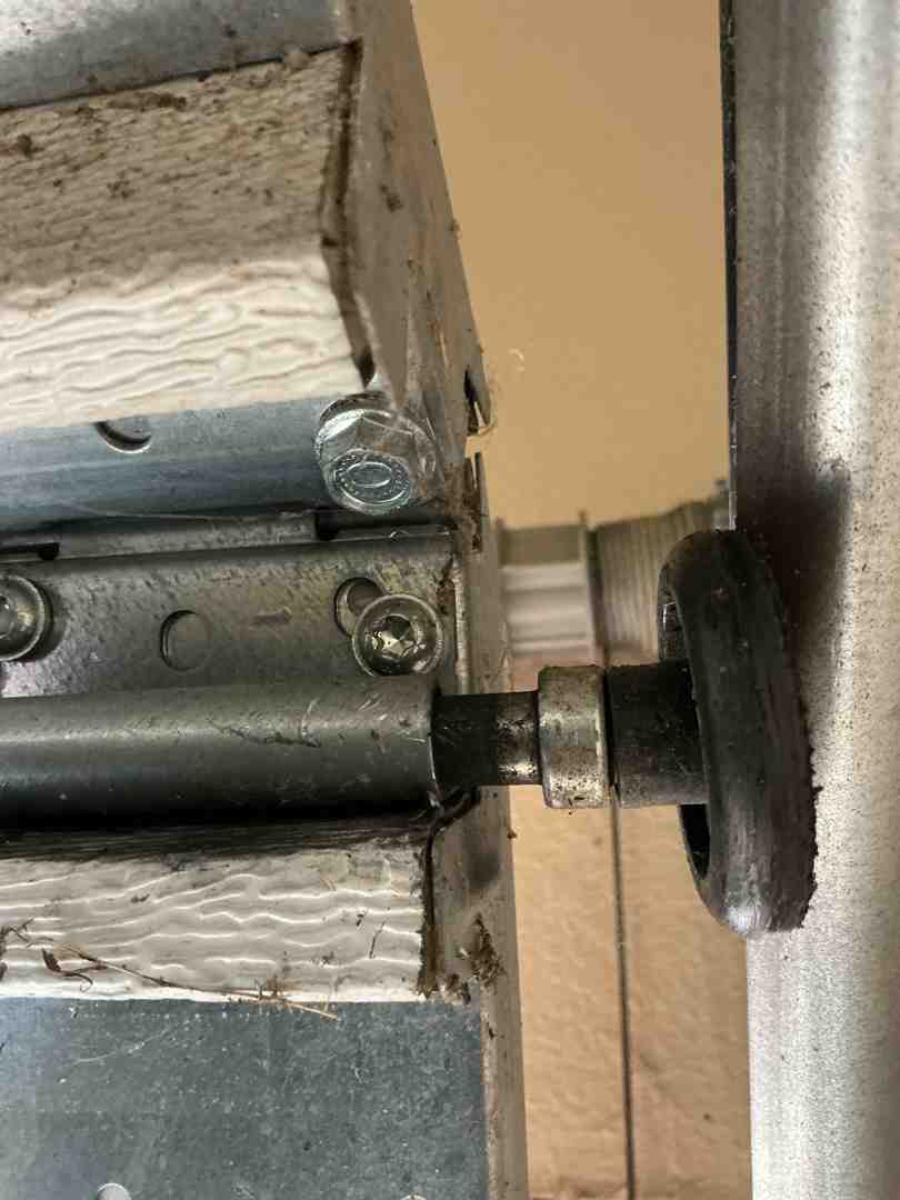 technician inspecting garage door rollers