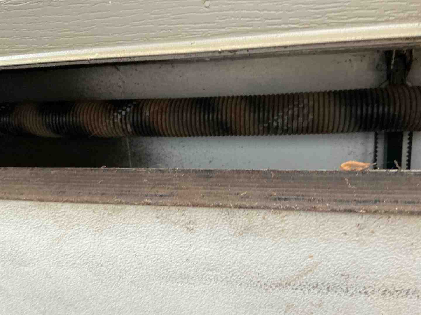 Rusted and corroded garage door spring coils showing metal fatigue
