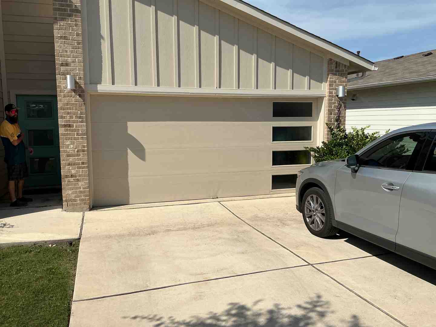 A beautiful, modern garage door installed on a contemporary Austin home, showcasing clean lines and durable materials A beautiful, modern garage door installed on a contemporary Austin home, showcasing clean lines and durable materials