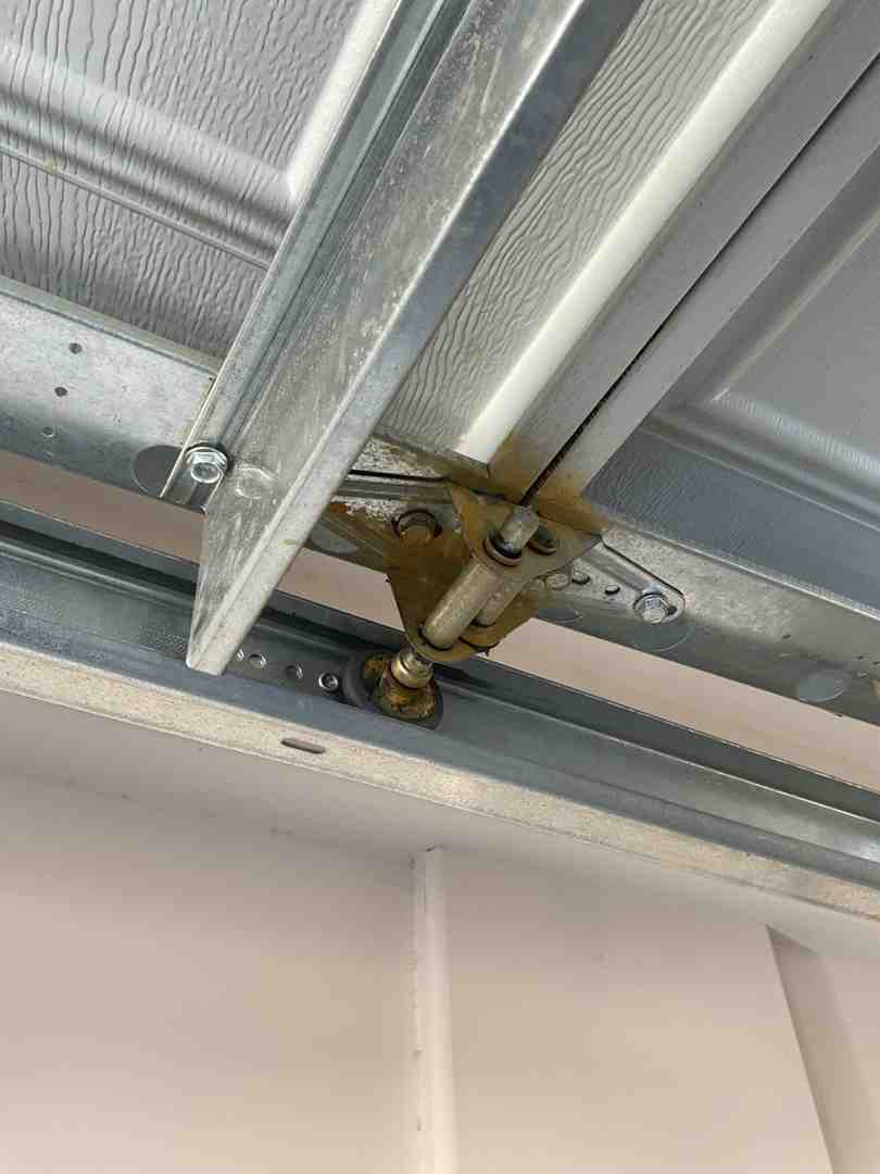 worn garage door springs and tracks showing signs of rust and dust buildup worn garage door springs and tracks showing signs of rust and dust buildup