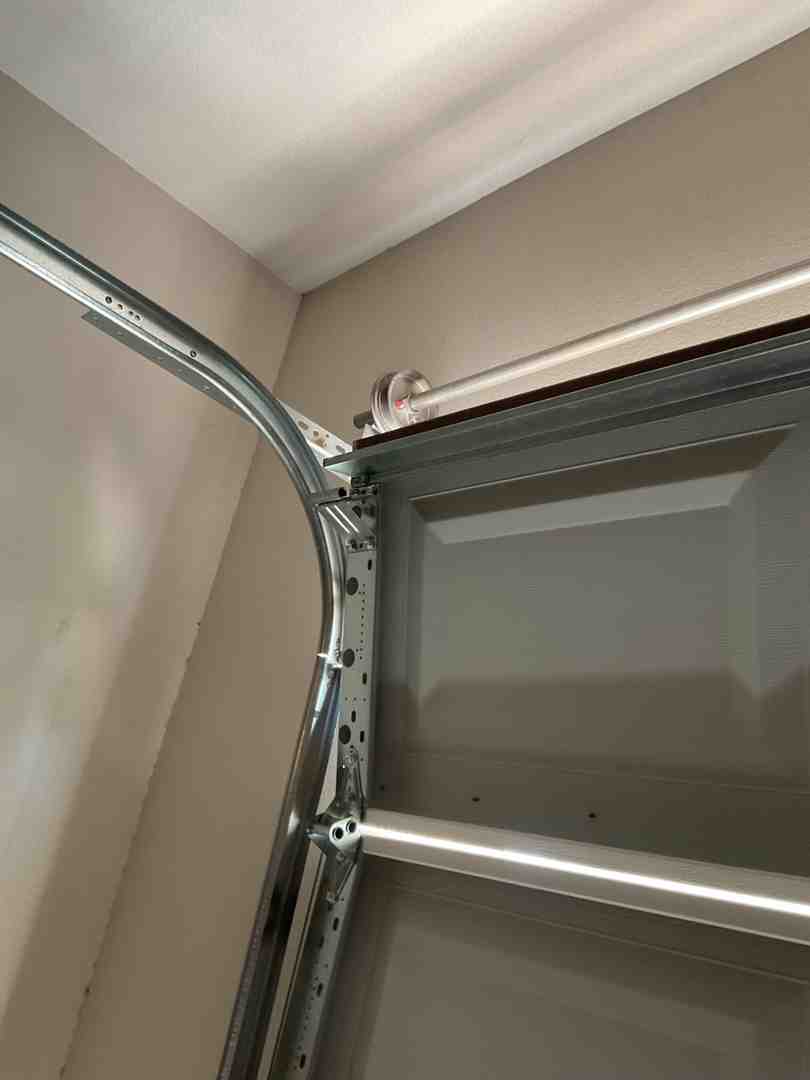 clean garage door track and rollers showing proper alignment clean garage door track and rollers showing proper alignment