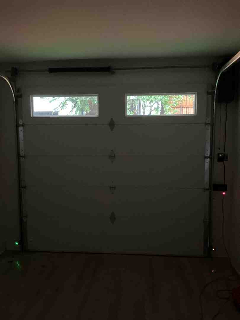 Inside view of modern garage door showing tracks and safety sensors Inside view of modern garage door showing tracks and safety sensors