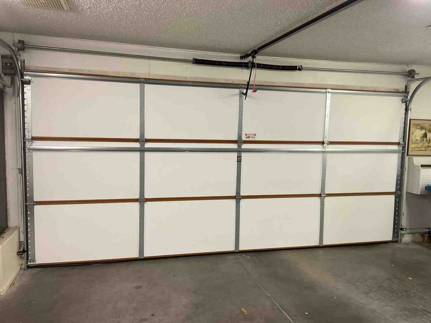 A high-quality multi-layer steel garage door showing the inner insulation layer A high-quality multi-layer steel garage door showing the inner insulation layer