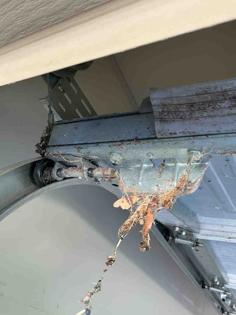 homeowner cleaning garage door tracks homeowner cleaning garage door tracks