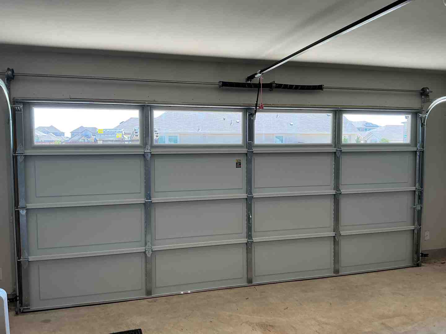 A modern garage door showing correct interior tracks on an Austin home