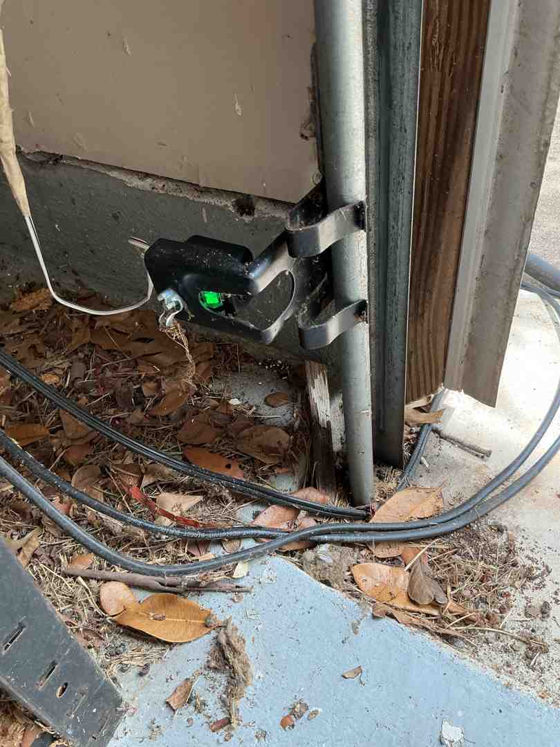 homeowner inspecting garage door sensor wiring