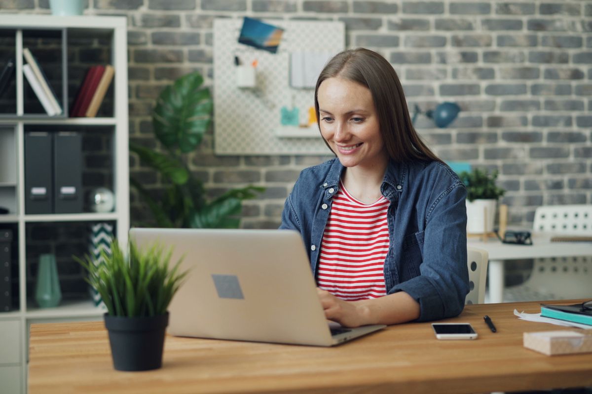 Freelancer registering a sole proprietorship online from a bright workspace