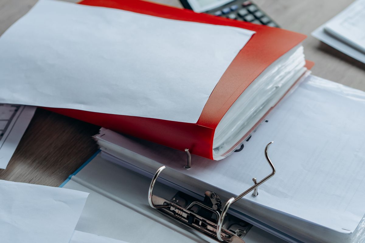 Folders of documents prepared for a karta pobytu application in Poland