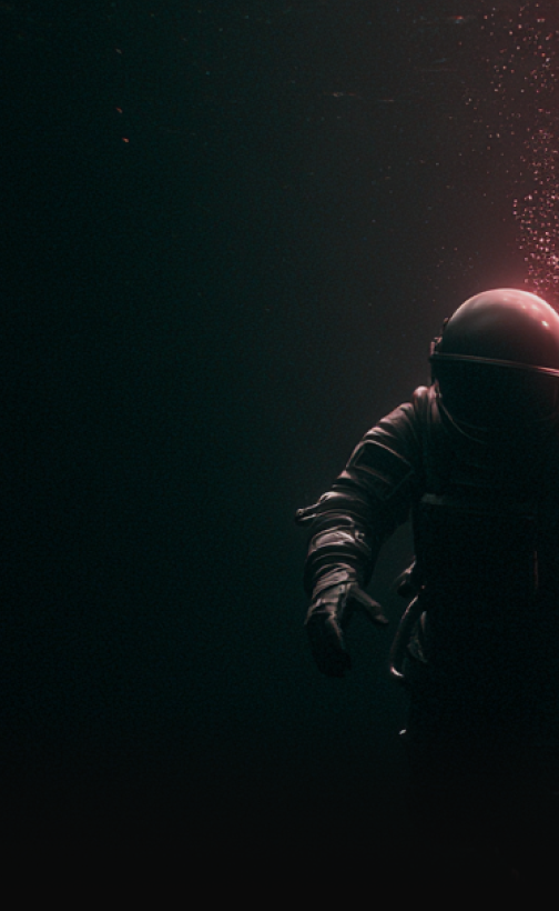 Astronaut submerged in dark water with pink light and bubbles rising.
