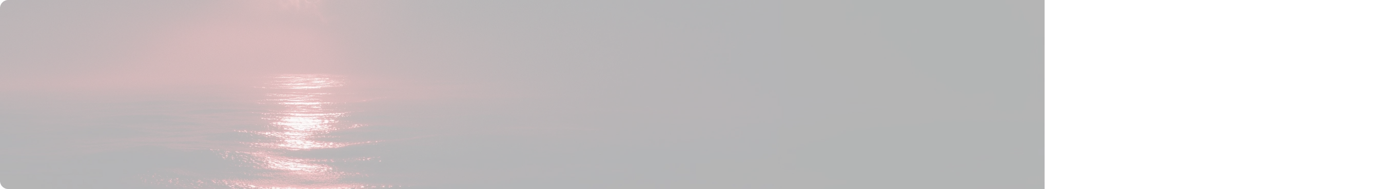 Ocean surface reflecting red light under a dark sky at dusk or dawn.