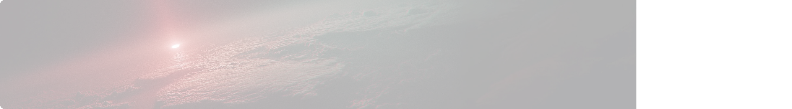 Dark aerial view of cloud tops illuminated by a red light glow from the upper left corner.