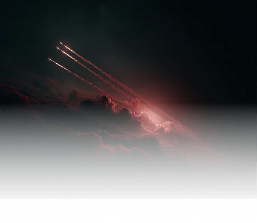 Three aircraft flying in formation, leaving bright contrails against dark red illuminated clouds.