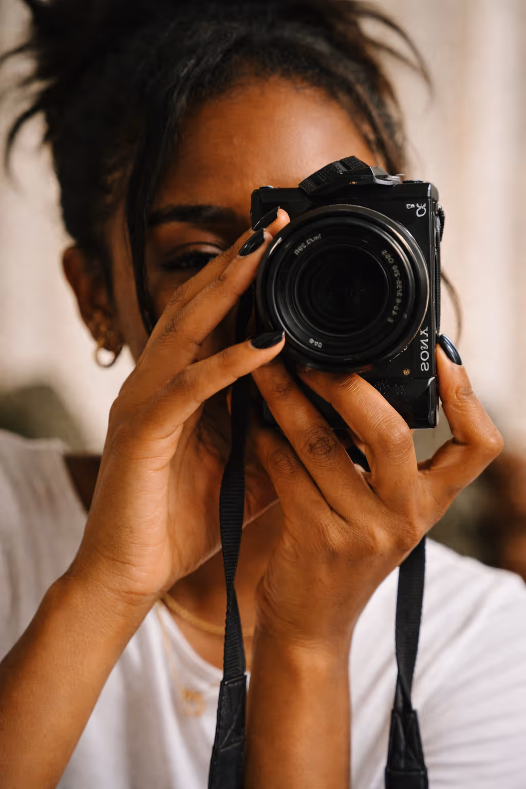 Two people walking past a wall with posters featuring a shirtless young man with wet hair and text about a pop-up event on October 13th.