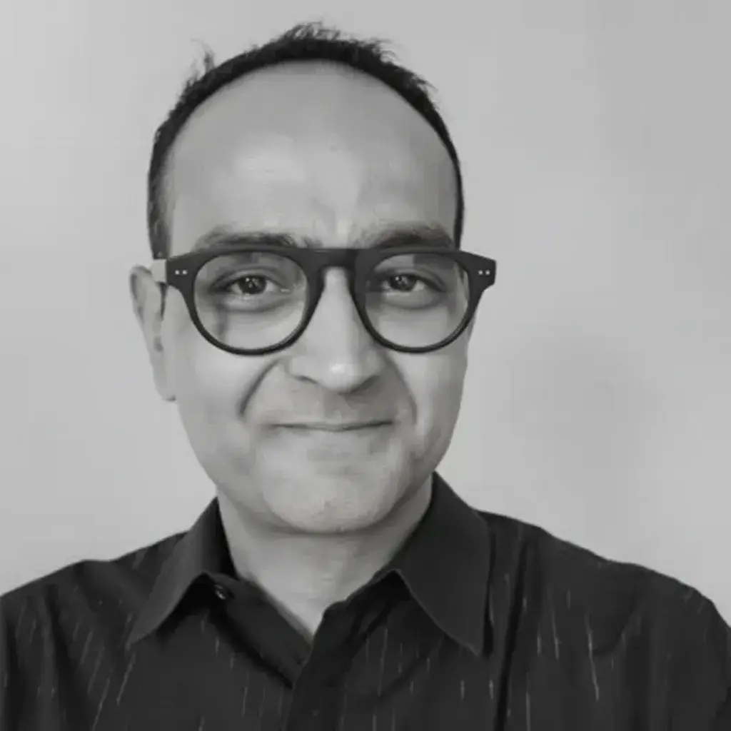 A man wearing glasses and a black shirt.