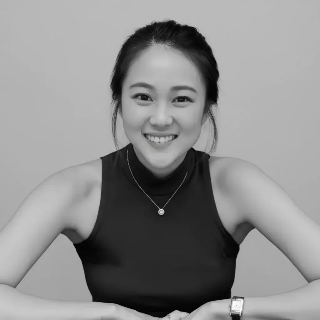 A woman sitting in a chair smiling for the camera
