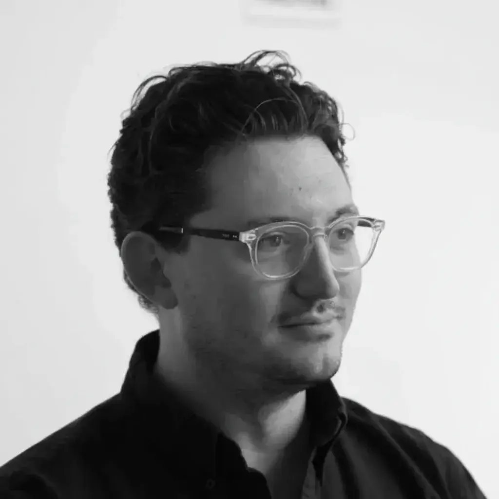 A black and white photo of a man wearing glasses