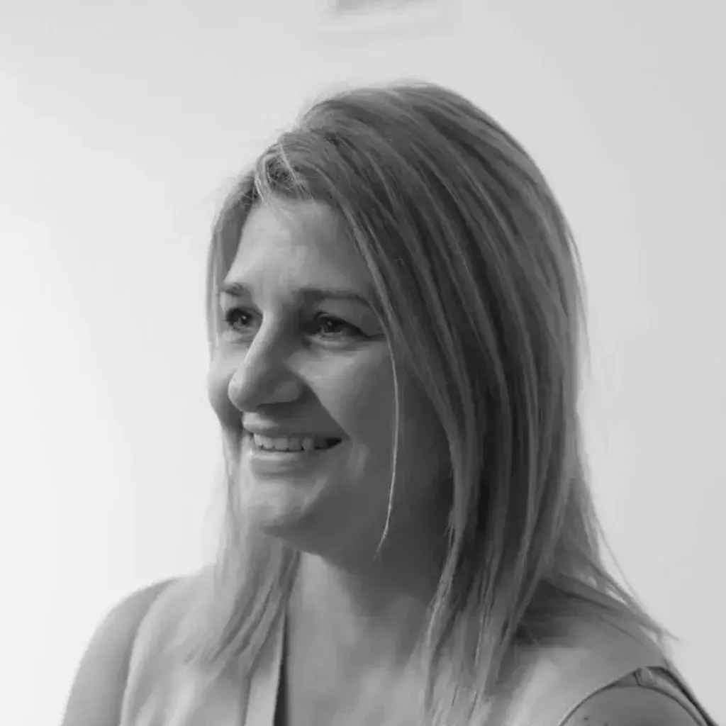 A black and white photo of a woman smiling