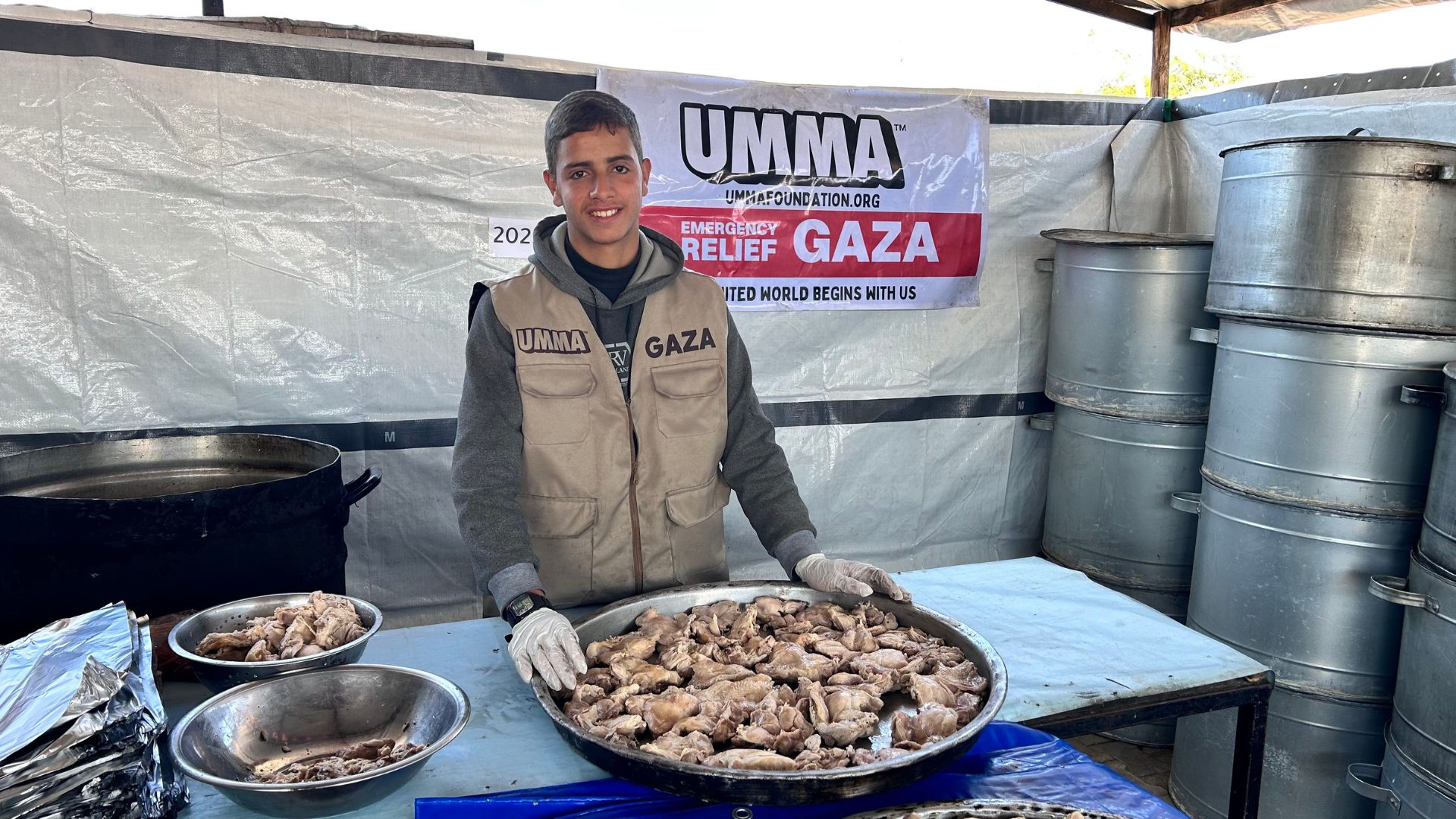 UMMA volunteer serves hot meals in Gaza food relief.