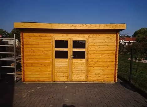 Ein hölzerner Gartenhaus mit Doppeltür und zwei Fenstern bei klarem Himmel.