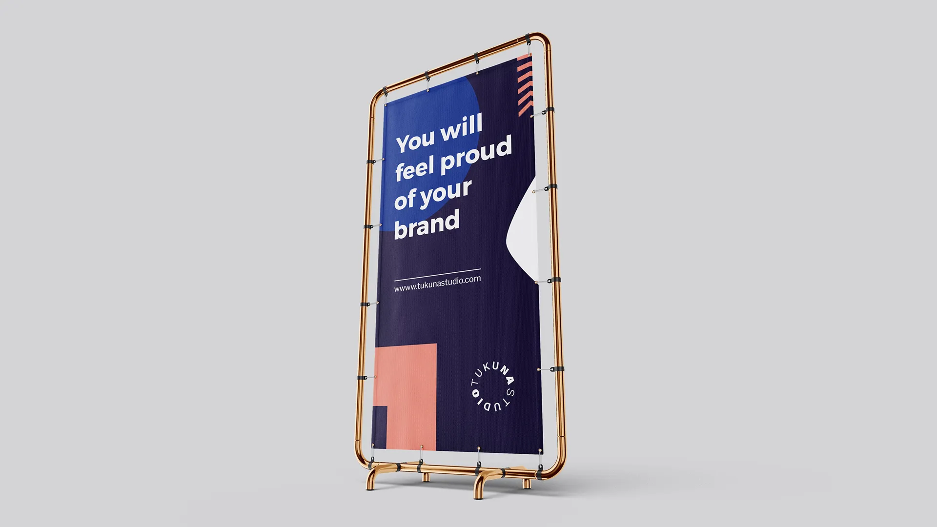 Banner on metal stand reading 'You will feel proud of your brand' with tukunastudio.com URL and logo.
