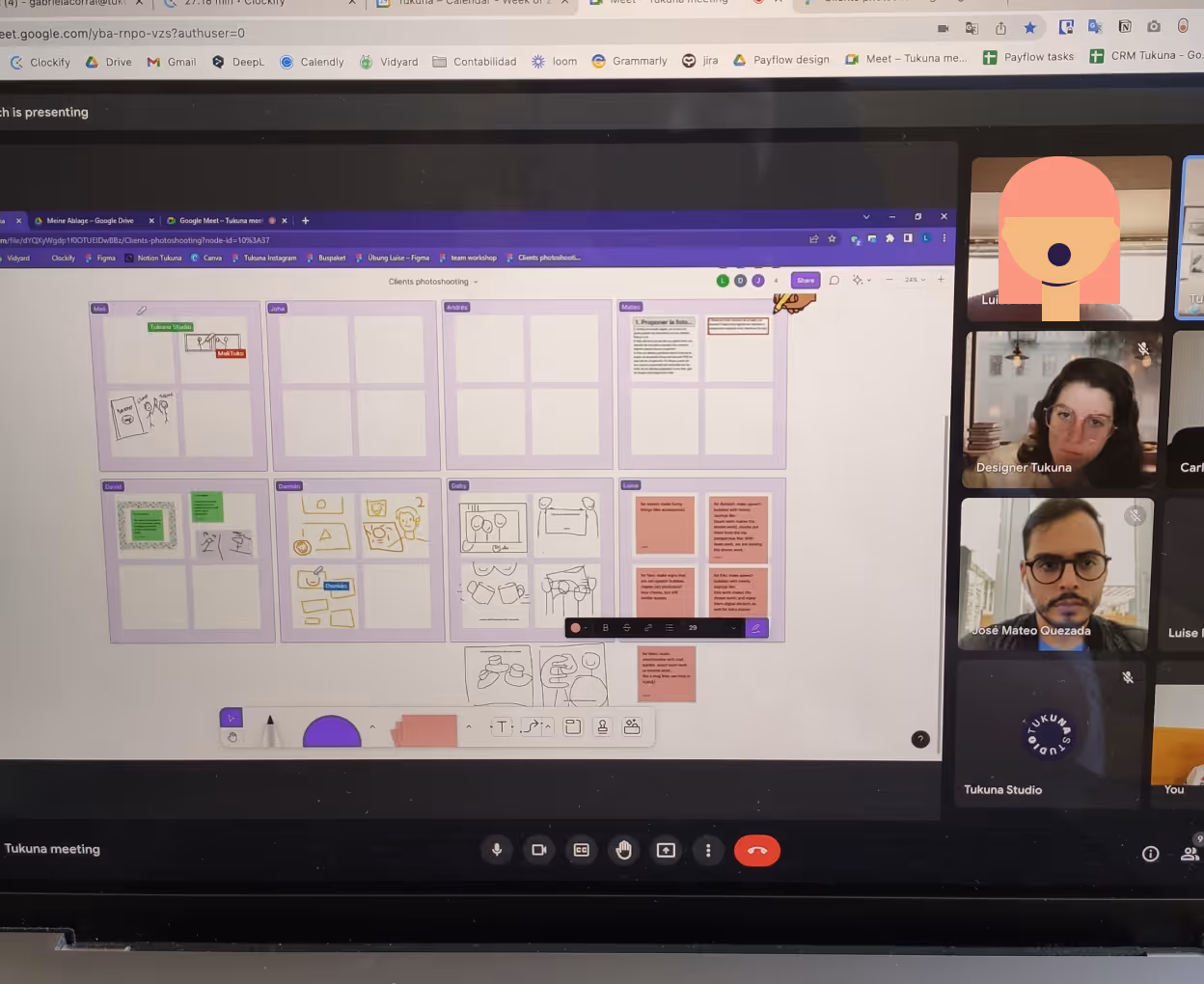 Virtual meeting screen showing a collaborative whiteboard with sketches and notes, alongside video thumbnails of five participants.