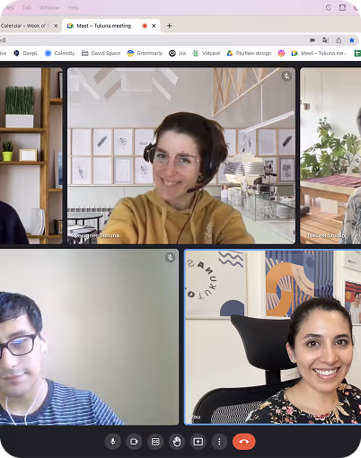 Video call screen showing four participants smiling, each in separate home or office settings.