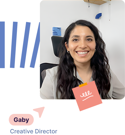 Smiling woman with long dark hair sitting in an office chair with a white wall background.