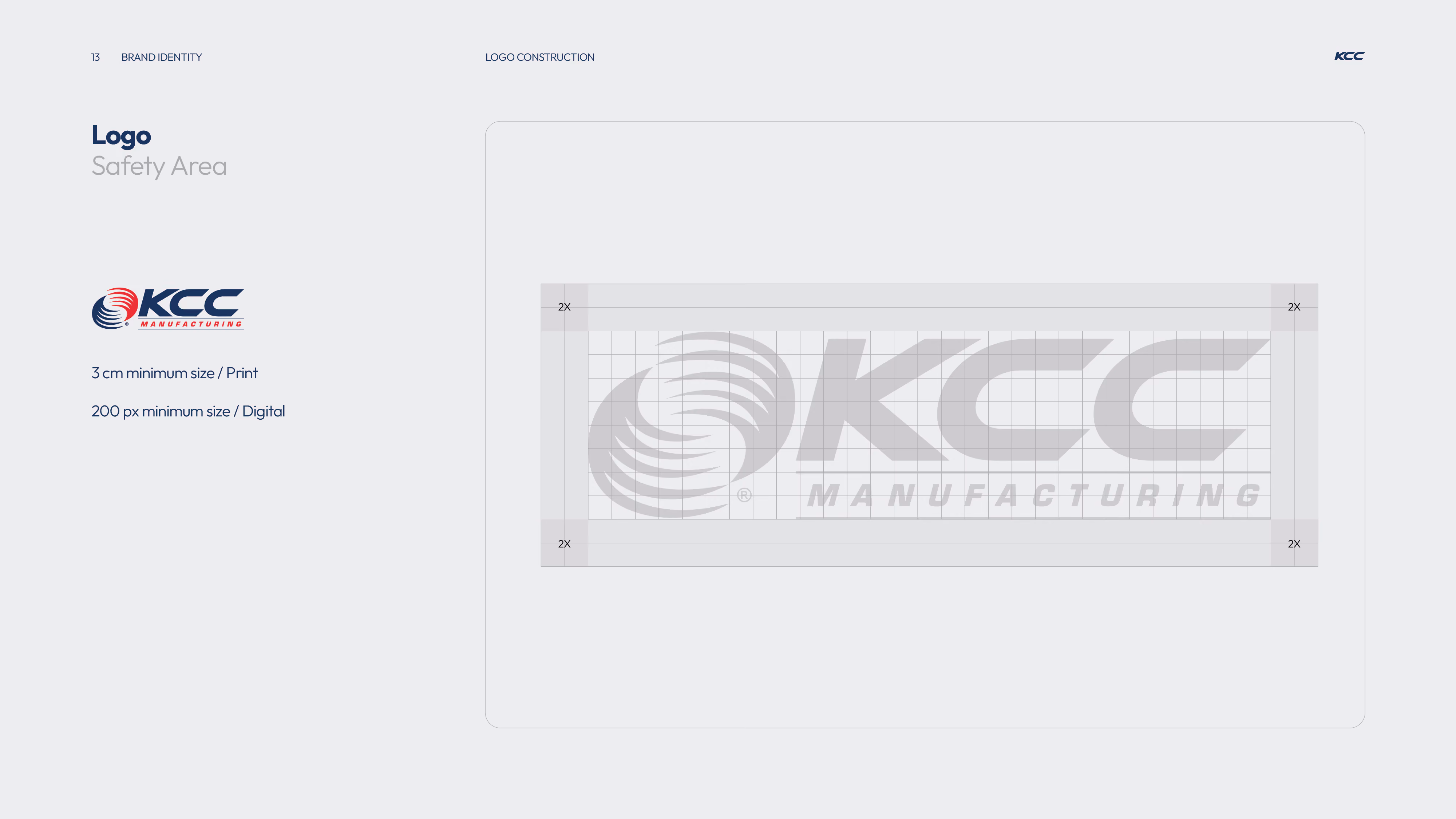 KCC Manufacturing logo with a circular swirl design to the left, in navy blue and red colors, shown with a grid overlay illustrating a safety area buffer zone of 2X on all sides and minimum size guidelines of 3 cm for print and 200 px for digital use.