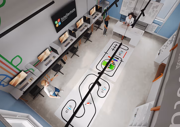 Overhead view of a modern classroom with two students and a teacher, computer workstations along one wall, and robotic tracks on the floor labeled 'elīz labs'.