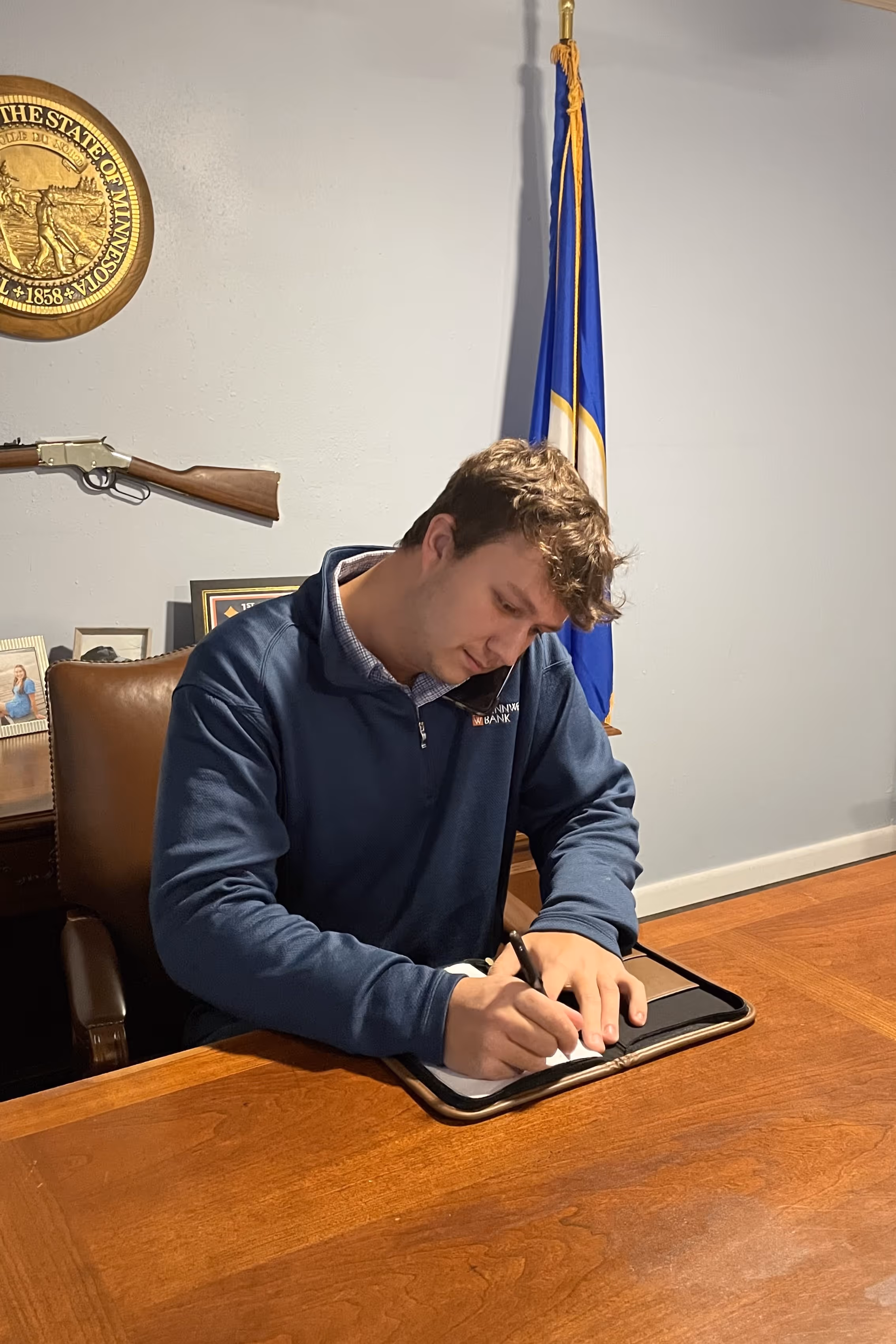 Braxton on the phone and writing down notes.