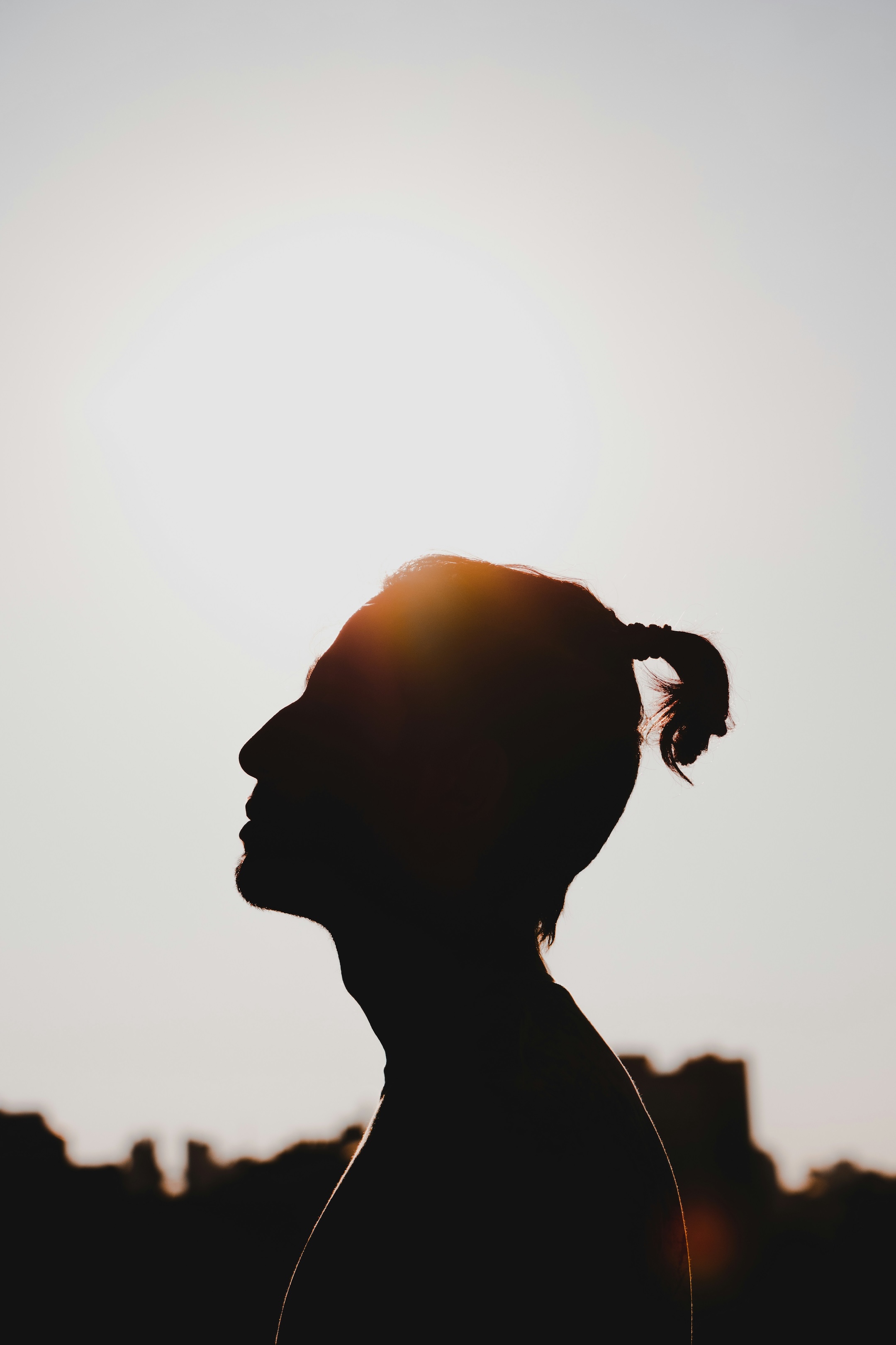 Silhouette of a person in profile at sunrise, reflecting the calm, human centered support and self reflection described in the article on Person-Centered Therapy.