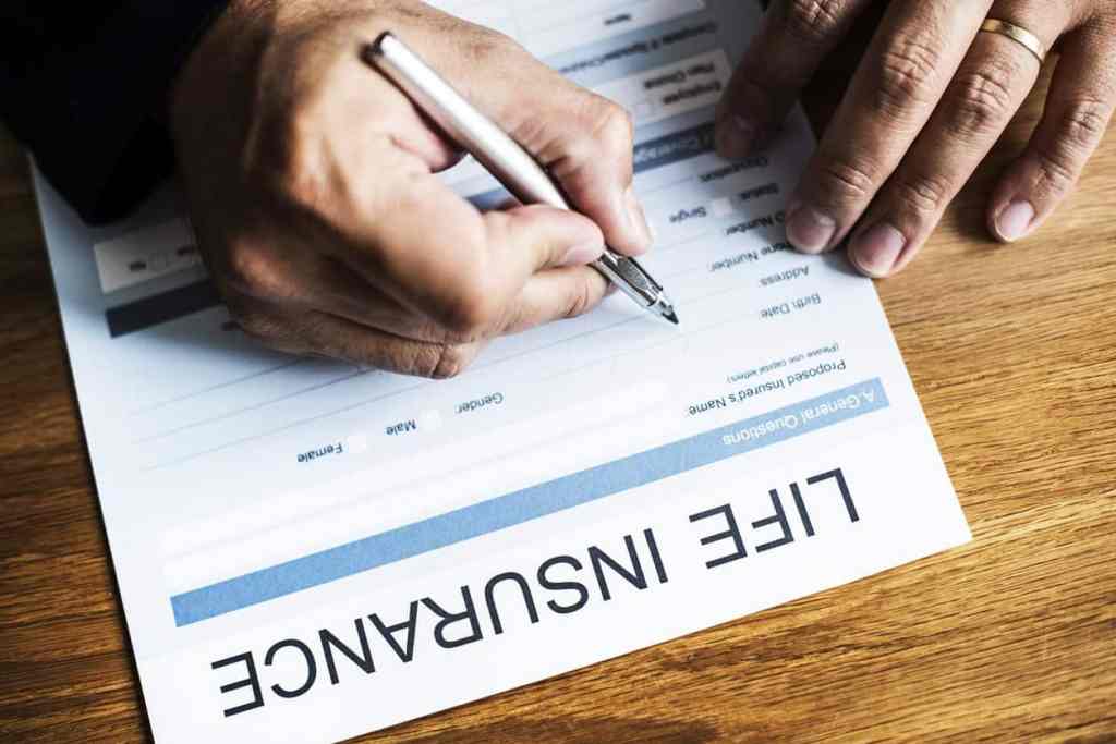 Signing life insurance documents as a solution to the problem how to build wealth in your 40s.