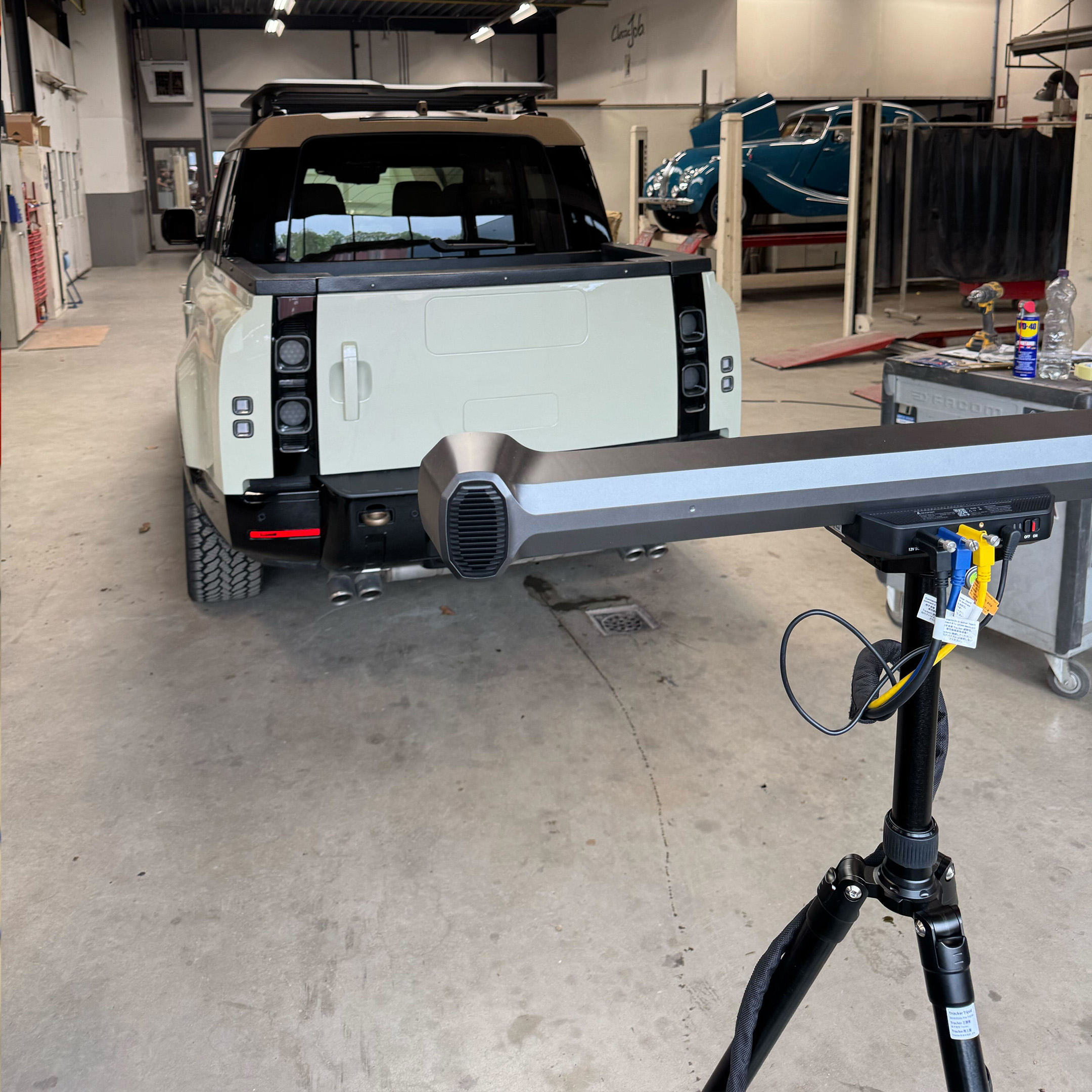 The tracking bar set up behind a Land Rover Defender