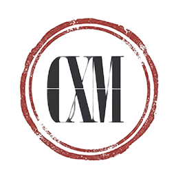 Stylized black and white CM logo inside a rough red circular stamp border.