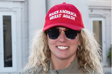 A portrait of Ashley-Nicole Russell wearing a Make America Great Again hat
